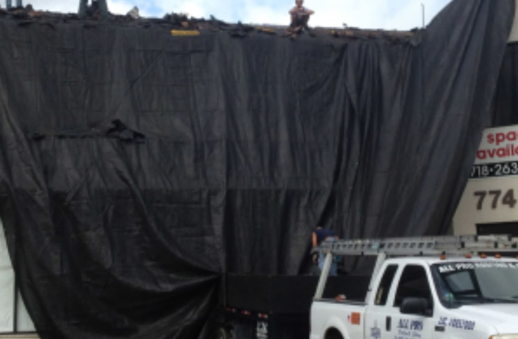 A truck parked in front of a black tarp.